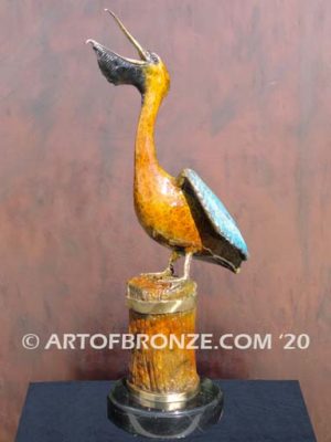 Bronze sculpture of playing pelican swallowing a fish