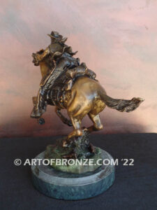Great Escape bronze sculpture cowboy riding horse with reins in hands