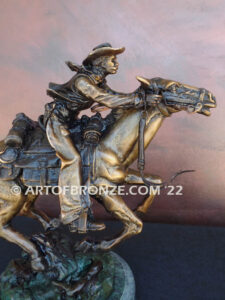 Great Escape bronze sculpture cowboy riding horse with reins in hands