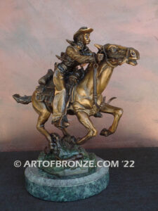 Great Escape bronze sculpture cowboy riding horse with reins in hands