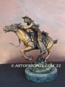 Great Escape bronze sculpture cowboy riding horse with reins in hands