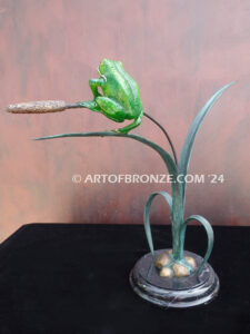 Hangn out tree frog sitting on cattail bronze statue
