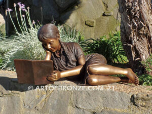 Honor Roll bronze sculpture of girl lying down looking at book