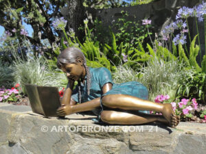 Honor Roll bronze sculpture of girl lying down looking at book