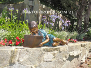 Honor Roll bronze sculpture of girl lying down looking at book