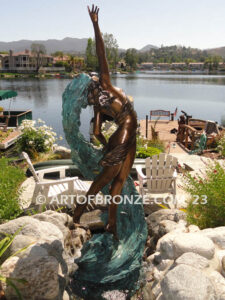 Inspirare beautiful woman leaping upward with spiraling wave design around her bronze statue