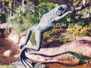 King of the Pond giant frog jumping statue monument with big, webbed toes and eyes
