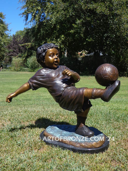 Lil Scorer bronze statue of boy playing AYSO soccer bicycle kicking ball