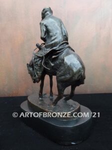 The Norther bronze statue after Frederic Remington featuring cowboy caught in forceful winds atop his horse