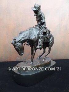 The Norther bronze statue after Frederic Remington featuring cowboy caught in forceful winds atop his horse