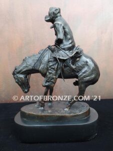 The Norther bronze statue after Frederic Remington featuring cowboy caught in forceful winds atop his horse