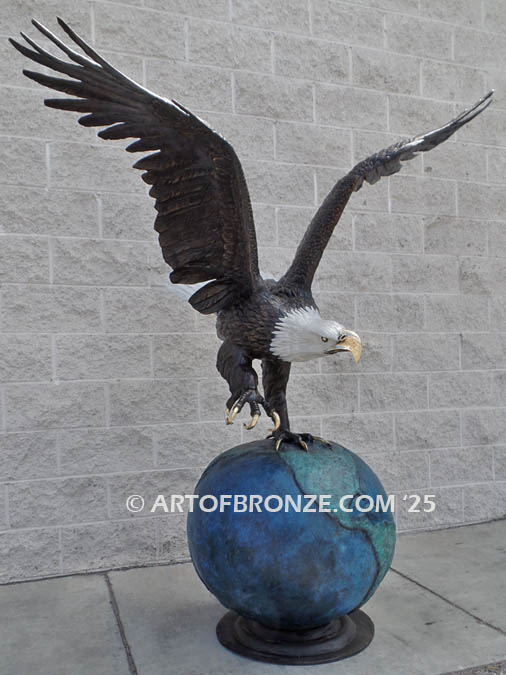 On Eagles Wings bronze sculpture of eagle grasping globe monument for public art