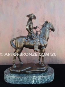 On the Range bronze sculpture of western cowboy on cattle horse