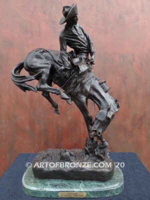 Outlaw bronze statue cowboy on bucking horse after Frederic Remington
