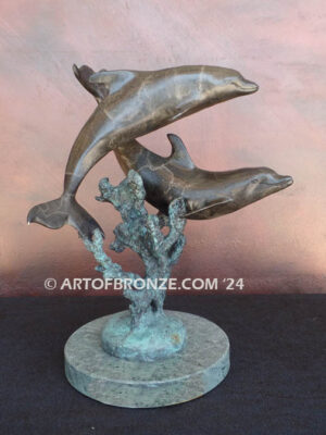 Playmates dolphins playfully swimming together bronze statue