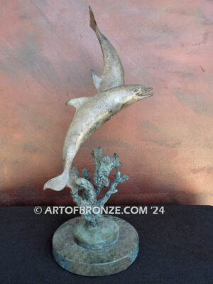 Playmates dolphins playfully swimming together bronze statue