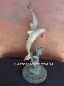 Playmates dolphins playfully swimming together bronze statue