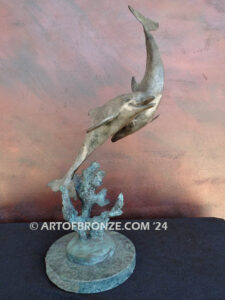 Playmates dolphins playfully swimming together bronze statue