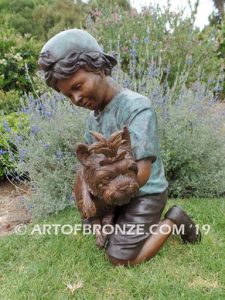 Play Pal bronze sculpture of young boy holding his dog