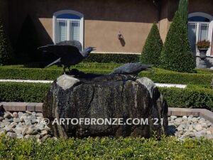 Raven bronze sculpture of standing ravens playing around fountain