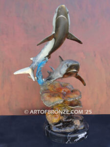 Two swimming great white sharks along a coral reef bronze statue