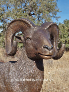 Rocky Mountain King monumental outdoor bronze sculpture big horn sheep ram on bronze rock ledge