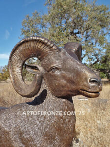 Rocky Mountain King monumental outdoor bronze sculpture big horn sheep ram on bronze rock ledge