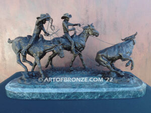 Round Up rodeo bronze sculpture of cowboys on horseback catching a steer