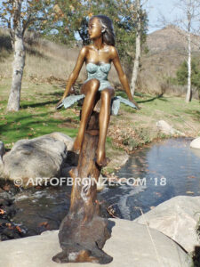 Sanctuary bronze statue beautiful girl gracefully resting on branch in bathing suit