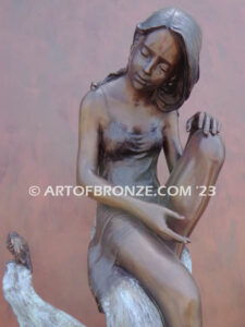 secret garden bronze statue beautiful girl gracefully resting on pampas grass leaf