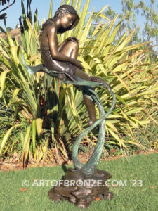 secret garden bronze statue beautiful girl gracefully resting on pampas grass leaf