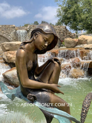 secret garden bronze statue beautiful girl gracefully resting on pampas grass leaf