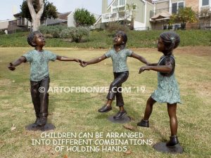 Sing Along wonderful outdoor bronze sculpture featuring three young kids holding hands and dancing