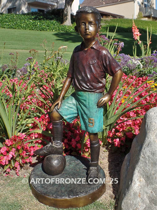Soccer Star bronze statue of AYSO soccer player getting ready to play his game
