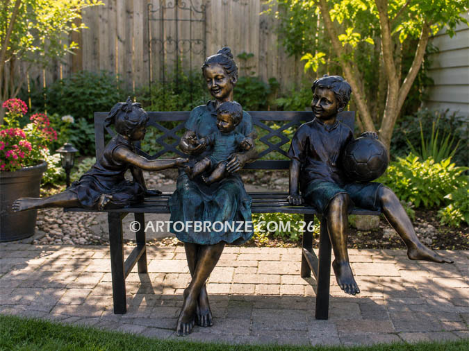 Special Day Together bronze family statue of mother sitting on bench with her children