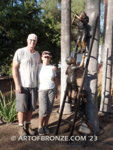 Team work bronze statue of two boys climbing on ladder for outdoor display