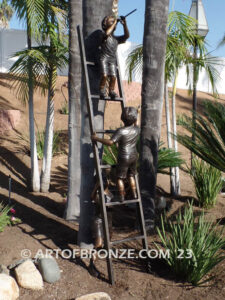 Team work bronze statue of two boys climbing on ladder for outdoor display