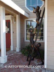 Team work bronze statue of two boys climbing on ladder for outdoor display