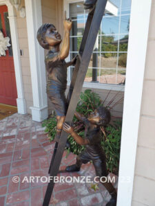 Team work bronze statue of two boys climbing on ladder for outdoor display