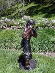 Teed up bronze sculpture of junior golfer practicing for USPGA