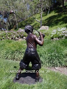 Teed up bronze sculpture of junior golfer practicing for USPGA