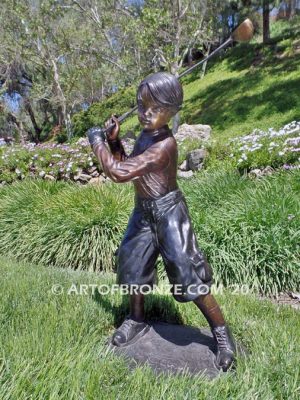 Teed up bronze sculpture of junior golfer practicing for USPGA