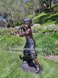 Teed up bronze sculpture of junior golfer practicing for USPGA