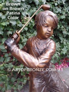 Teed up bronze sculpture of junior golfer practicing for USPGA