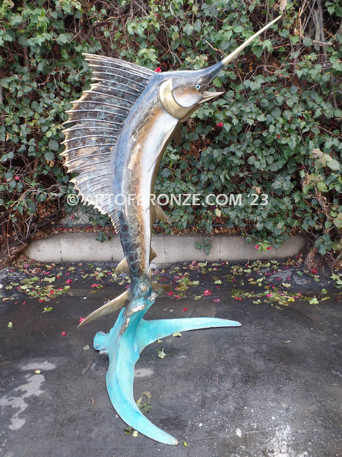 bronze statue leaping sailfish that can spray water from bill into estate fountain