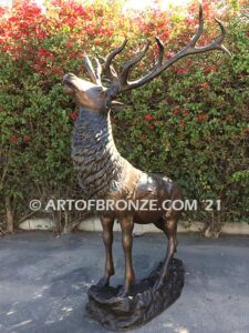 Unyielding Terrain Heroic bronze bull elk standing on rocky base design with head raised in bugling position