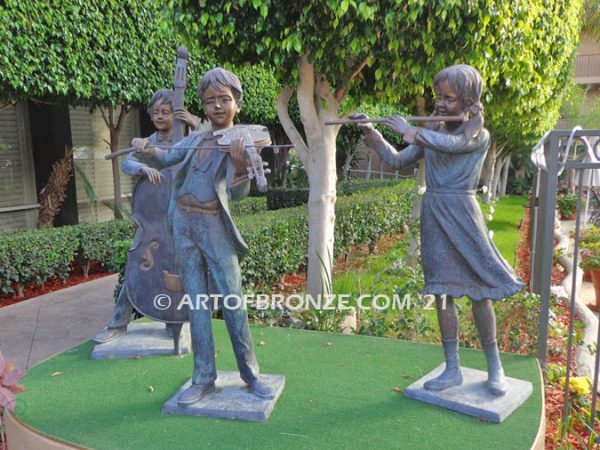 Virtuoso Pals wonderful outdoor bronze sculpture featuring three children playing music concert