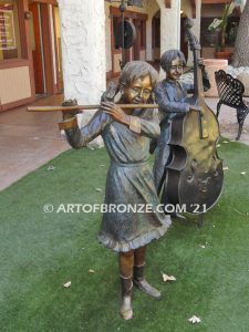 Virtuoso Pals wonderful outdoor bronze sculpture featuring three children playing music concert