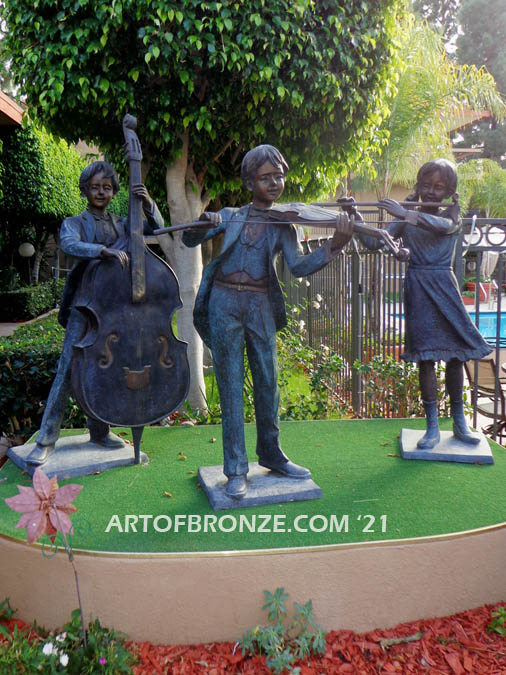Virtuoso Pals wonderful outdoor bronze sculpture featuring three children playing music concert