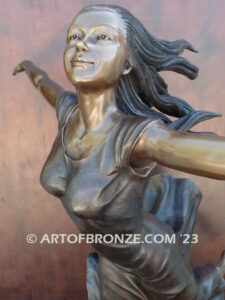 Wind Swept bronze statue joyous woman gracefully balancing on one foot